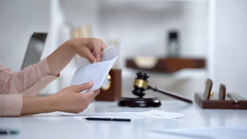 Divorced woman holding envelope with alimony